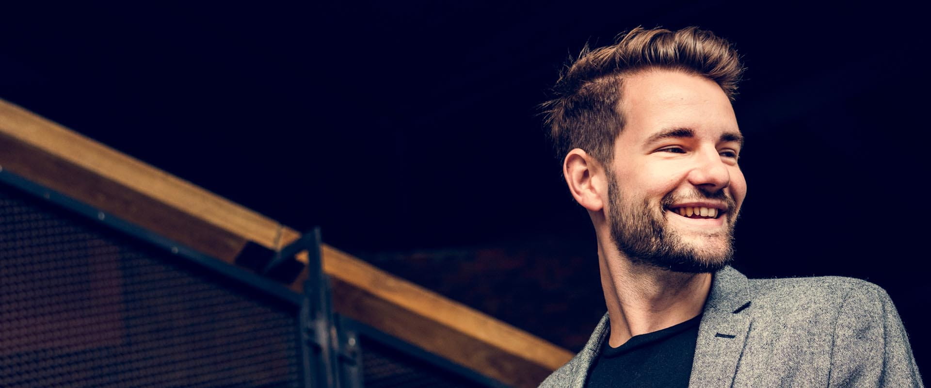 Male coworker smiling confidently in an office environment
